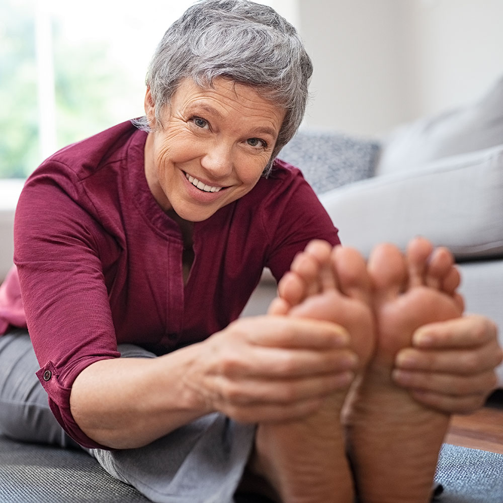 elderly woman getting a foot soak at home