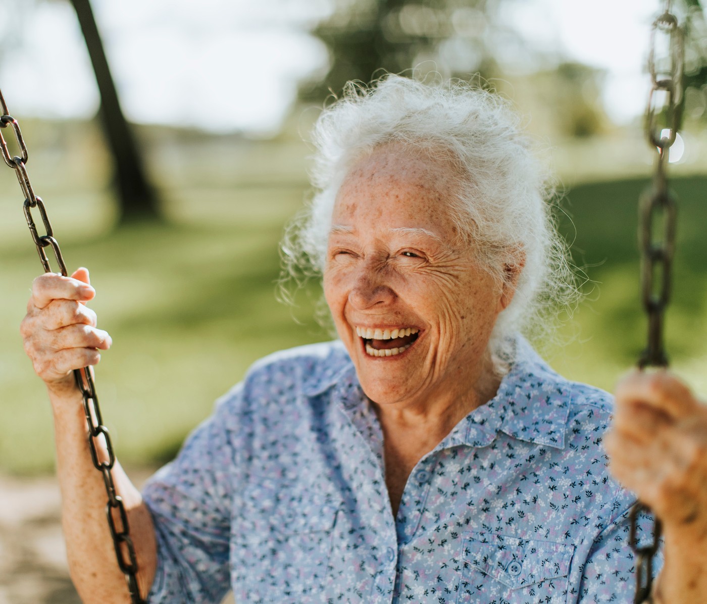 Cheerful senior woman on a swing 2