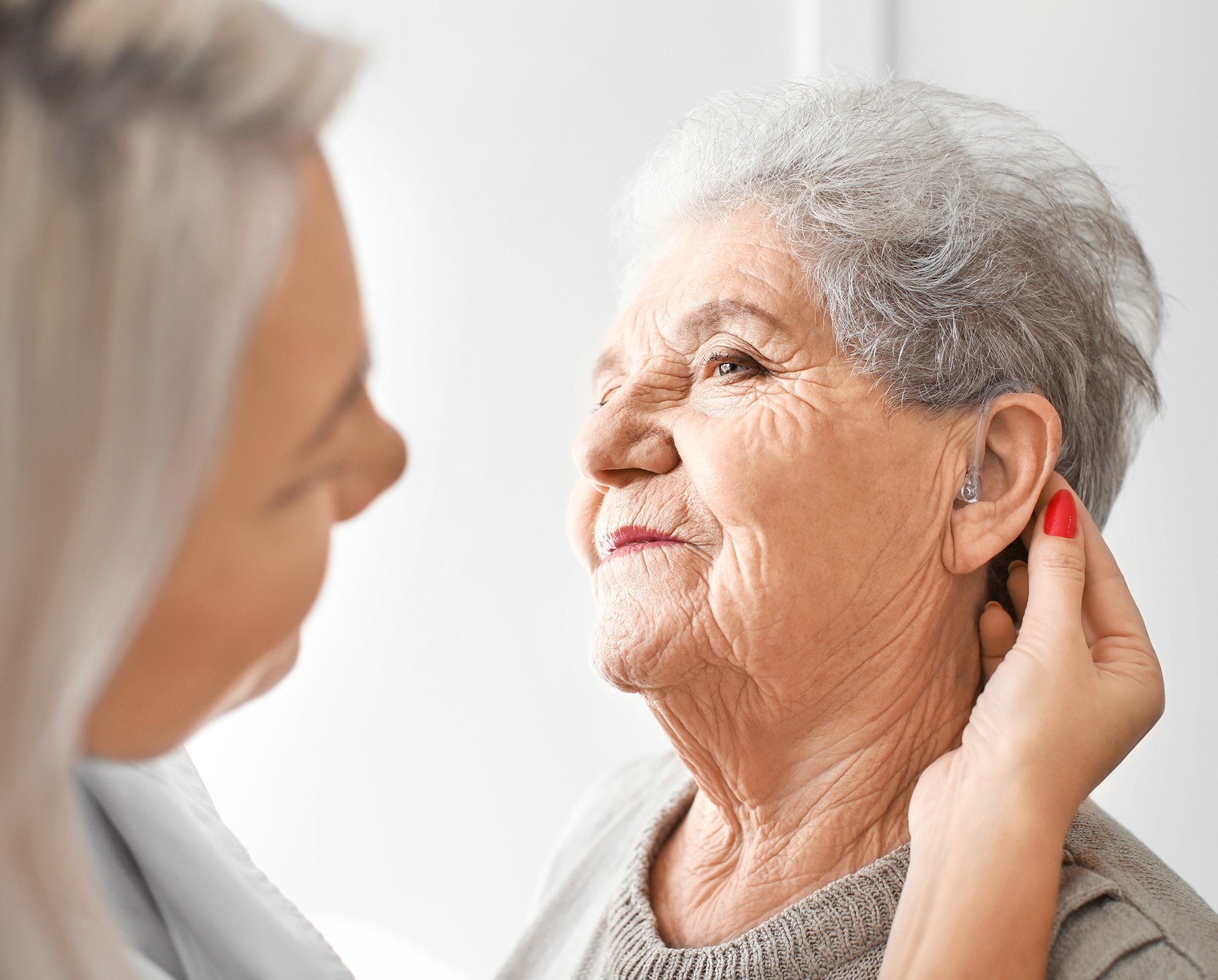 hearing aid in senior woman's ear 2